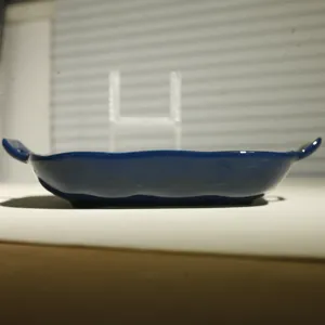 Blue ceramic baking dish detail, double handle rectangle oven tray for delicious food.