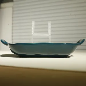 Detailed view of the dark teal ceramic baking dish with double handles, ideal for oven use.