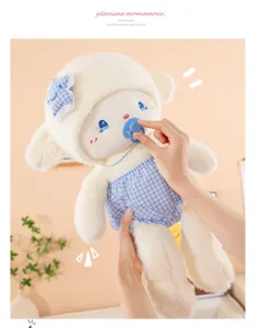 Detail view of the cute plush sheep toy with blue checkered shorts and pacifier. Soft texture.