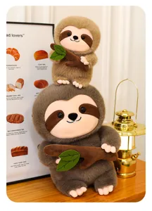 Dettaglio di peluche bradipo carino, animale di peluche morbido con foglie verdi e luci calde.
