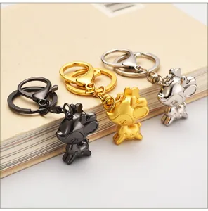 Detailed close-up of metallic deer keychains in black, gold, and silver finishes