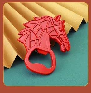 Detail macro of a red metal horse head bottle opener with geometric engraved design