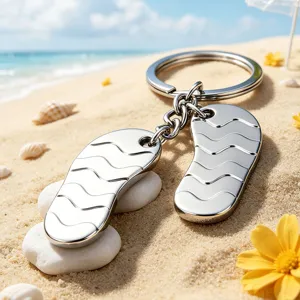 High-quality polished metal flip-flop keychain charms on a scenic sandy beach background
