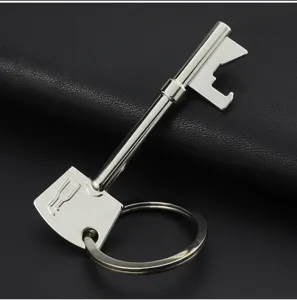 Detail of creative key-shaped beer bottle opener keychain with polished silver finish.