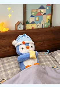 Cute blue penguin plush toy with sleeping cap and small pillow for kids gift room decor.