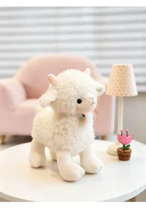 Cute fluffy sheep plush toy detail showing soft white texture and cute little horns in room.