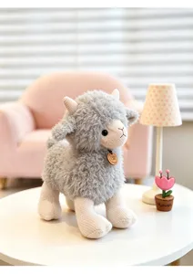 Cute grey plush sheep toy detailed view featuring soft fleece body and knit face legs.
