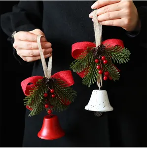 Close-up of Nordic style Christmas bell ornaments with pine branches and red berries