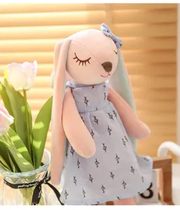 Cute lop-eared bunny plush toy with soft pink body and lovely blue floral dress.