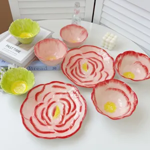 Hand-painted ceramic rose flower shaped bowls and plates set with exquisite petal texture.