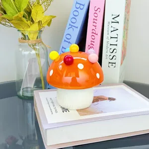 Detailed view of the cute ceramic mushroom storage jar with colorful decorative balls.