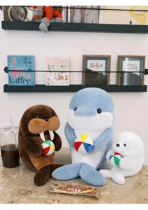 Cute plush animal detail shot showing lovely walrus, dolphin and seal dolls holding balls.