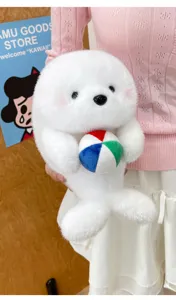 Close-up detail of a cute white plush seal toy holding a colorful ball, soft material.