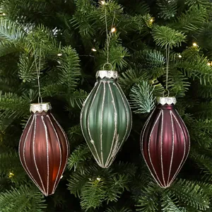 Set of three matte teardrop Christmas ornaments with glitter stripes on tree