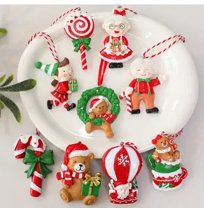 Detailed view of assorted festive resin Christmas tree hanging ornaments on a white plate
