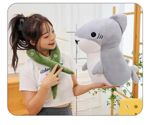 Detailed shot of a cute grey plush shark toy and green scarf in a cozy room setting.
