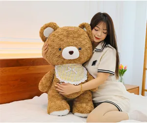 Brown plush bear toy detail view, cute stuffed animal doll for kids and girls birthday gift.
