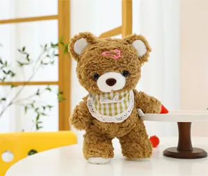 Cute mocha brown plush bear doll detail, soft stuffed animal toy with lovely bib and hair clip.