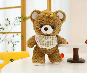 Detailed view of the cute brown plush teddy bear with a checkered bib and soft fabric.
