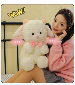 Cute fluffy lamb plush toy with pink bow, soft stuffed animal doll for kids and girls.