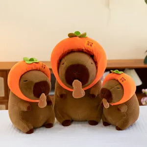 Cute capybara plush toy wearing cute orange hat holding peanut, soft stuffed doll gift.