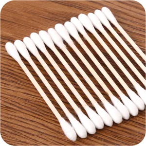 Double-headed cotton swabs with wooden sticks, neat arrangement, ideal for daily personal care.