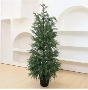 Detailed view of life-like artificial cedar Christmas tree in a sleek black pot