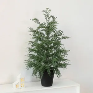 Elegant artificial cypress Christmas tree in a black pot for minimalist home decor