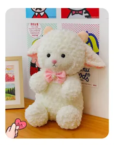 Cute fluffy white sheep plush toy detail, soft stuffed animal doll with pink bow for kids and girls.
