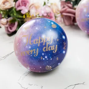Detailed close-up of a spherical starry tin candy box, featuring a gorgeous galaxy pattern.
