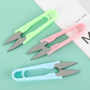 Detailed view of colorful U-shaped thread scissors, perfect for sewing, tailoring and crafts.