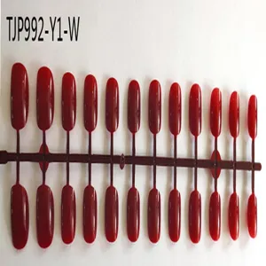 Short square red fake nail tips on plastic sprue for wholesale and DIY press on manicure art.