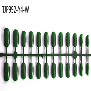 Green plastic false nail display board set with multiple fake nail tips for manicure.