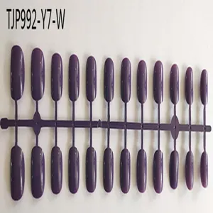 Detailed close-up view of dark purple press-on fake nail tips on a plastic mold sheet.