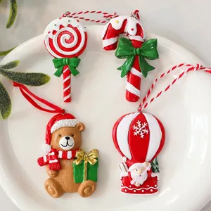 Close-up view of festive resin Christmas ornaments featuring Santa, bear, and candy cane