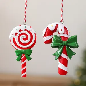 Detailed view of red and white resin Christmas lollipop and candy cane ornaments with green bows