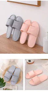 Detailed view of non-slip couple home slippers with textured strap design and cozy bedroom vibe.