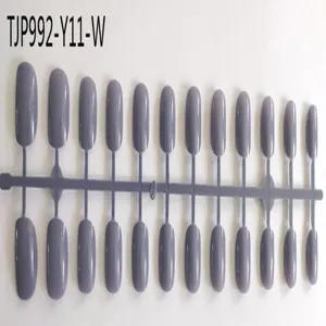 Close-up detail of grey purple press-on nail tips on plastic display stick, smooth surface.