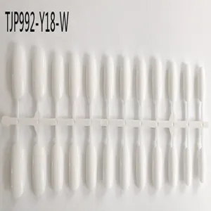 Close-up detail shot of white plastic false nail tips on a sprue for nail art display.
