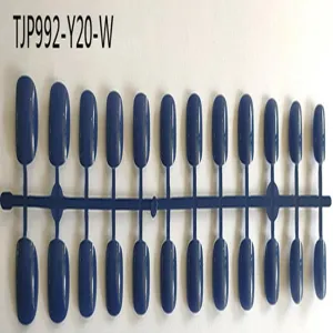 Factory wholesale short square un-oiled fake nail tips detail view on blue plastic sprue.