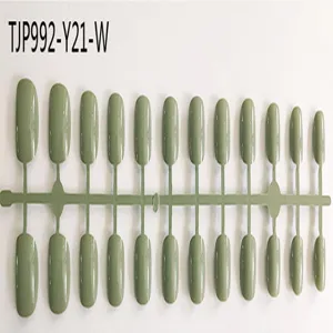 Green short round press-on false nail tips set, connected in a plastic card strip for nail art.