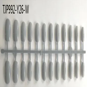 Close-up detail of grey short square round false nail tips on plastic runner mold.
