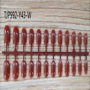 Short square fake nail tips set on plastic sticks, unpainted press on nails detail view.