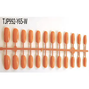 Detailed view of short square-round unoiled false nail tips on runner for DIY nail art design.