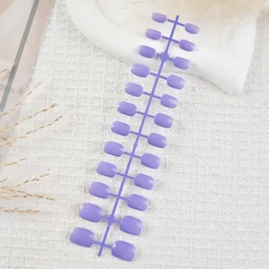 Short square press-on nail tips detail view, purple false nail strips for nail art designs.