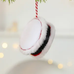 Festive Christmas plush drum ornament with fur trim and warm bokeh background lights.