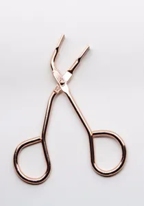 Rose gold magnetic eyelash curler detail, metal applicator tool for easy false lashes.