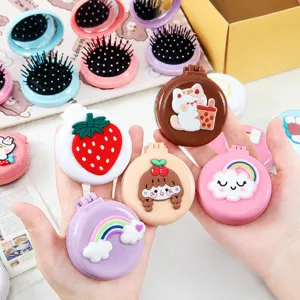 Portable folding mini hairbrush with mirror, cute cartoon design, compact pocket size for travel.