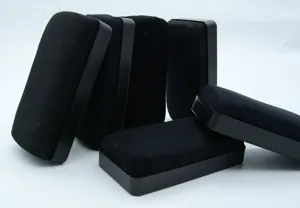 Close-up view of black whiteboard erasers with durable plastic shell and cleaning cloth surface.