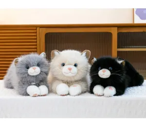 Detailed view of three realistic ragdoll cat plush toys in grey, beige, and black colors.